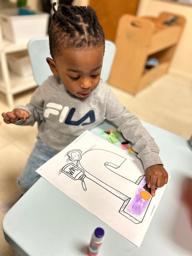 Staff greeting family at daycare front desk